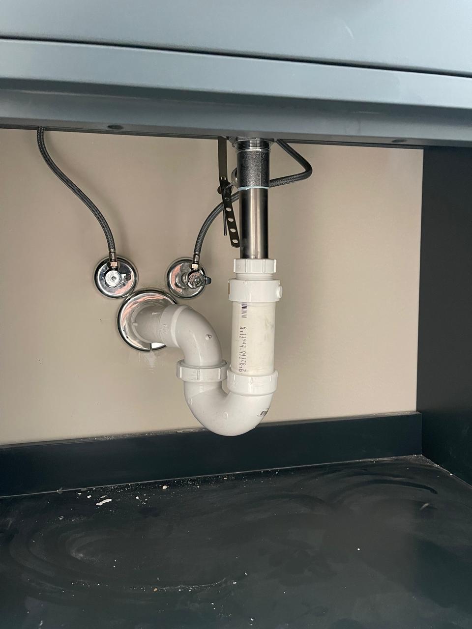 Finalized P-trap plumbing connection in bathroom sink