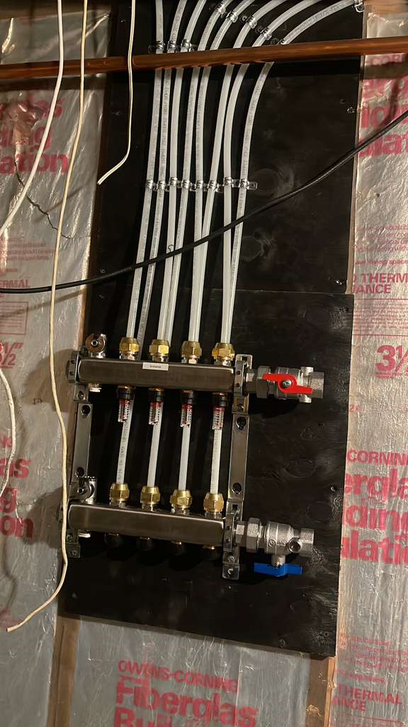 Installation of heated floor manifold and circulation piping