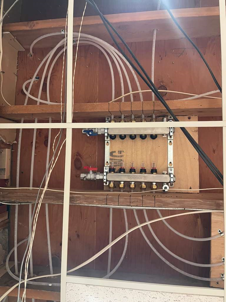 Heated floor manifold with supply and return connections