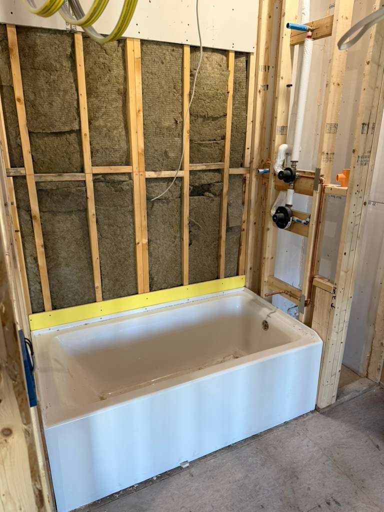 Tub valve and drain rough plumbing installation in bathroom