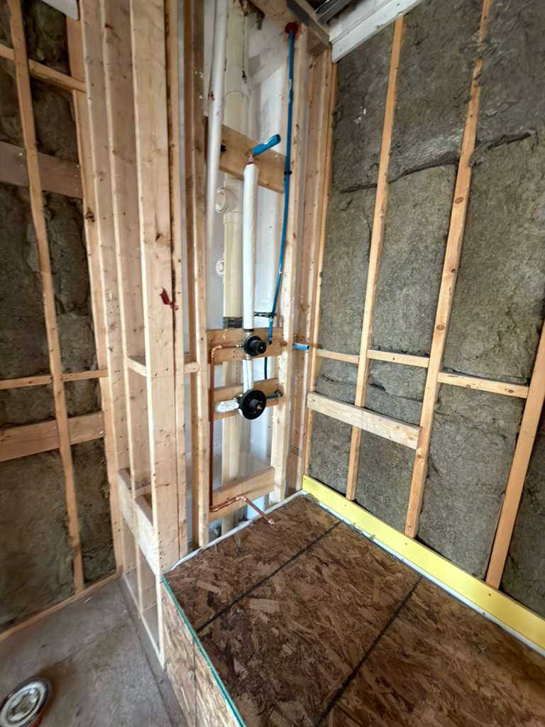 Shower valve plumbing installation in bathroom wall